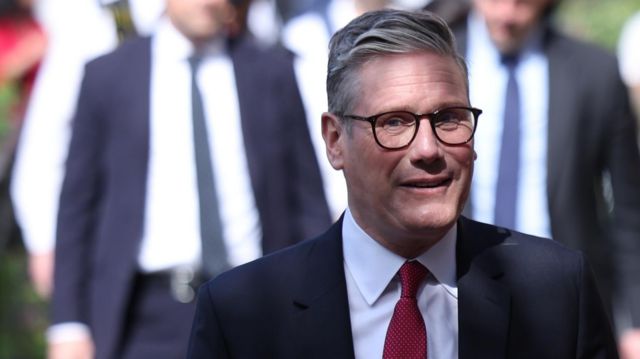 Labour leader Keir Starmer smiles outside a polling station