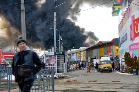 Black smoke rising into the sky from the market