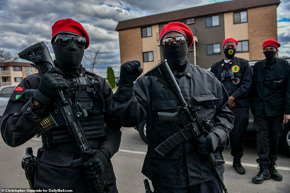 Pictured: Armed members of the New Black Panther Party standing in front of the Brooklyn Center Police Department