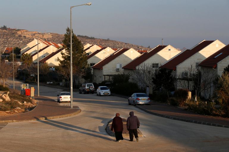 People walk near houses in the Israeli settlements of Ofra, in the occupied West Bank February 6, 2017