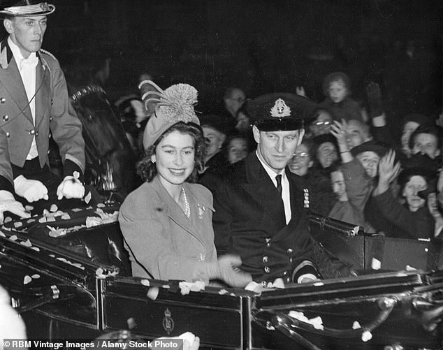 The then Princess Elizabeth is pictured with her new husband Philip Mountbatten as they leave Buckingham Palace for their honeymoon