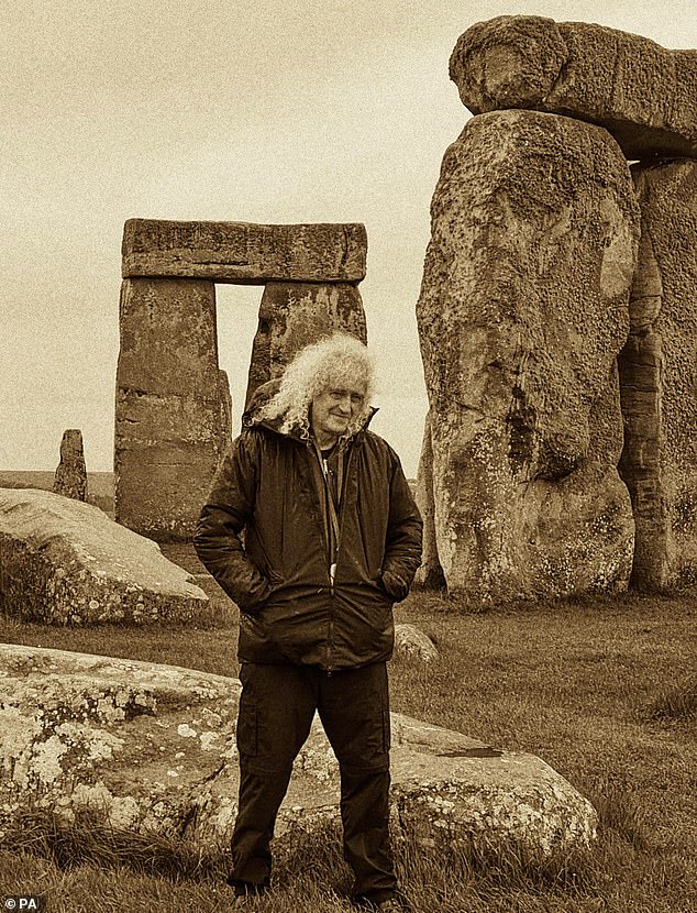 It will be displayed at the neolithic Wiltshire monument alongside a soundtrack of May playing Queen song Who Wants To Live Forever on the piano. Pictured: Brian May poses at Stonehenge