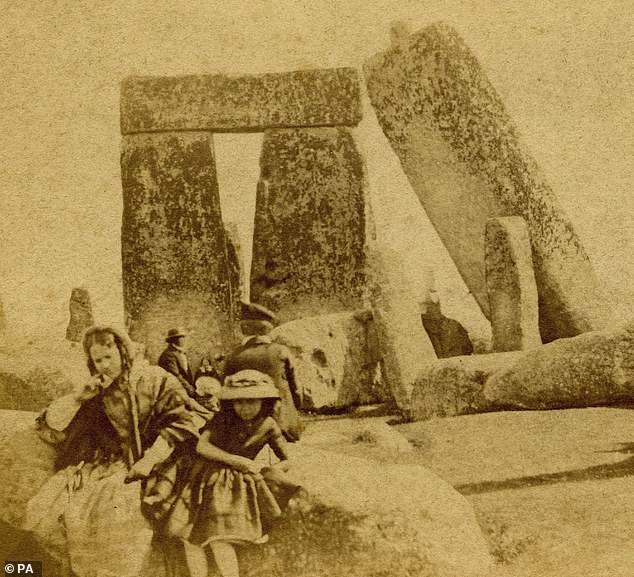 The oldest family photograph taken at Stonehenge (pictured) has been found in the collection of Queen guitarist Brian May, English Heritage has said