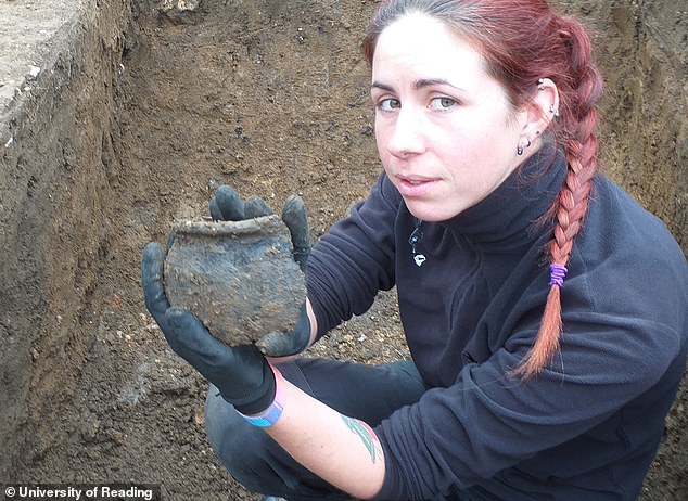 'The items that have been uncovered will allow us to piece together a detailed impression of how the monks and nuns who lived here ate, worked and dressed,' said Dr Thomas. 'This will shed new light on how Anglo-Saxon monasteries were organised and what life was like in them.' Pictured: University of Reading doctoral student and Anglo Saxon archaeologist Carina Mincioni holds a large fragment of Anglo Saxon pottery