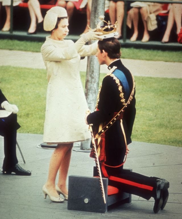 Queen Elizabeth II crowns her son Charles, Prince of Wales, during his investiture ceremony at Caernarvon Castle. 1969