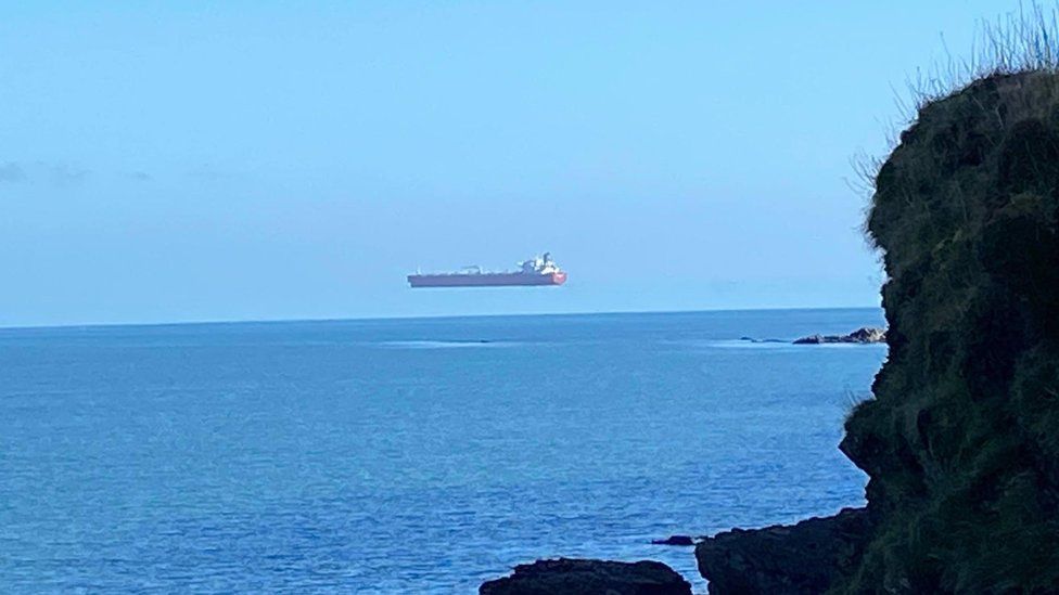 Hovering ship photographed off the coast of Cornwall Hovering ship photographed off the coast of Cornwall