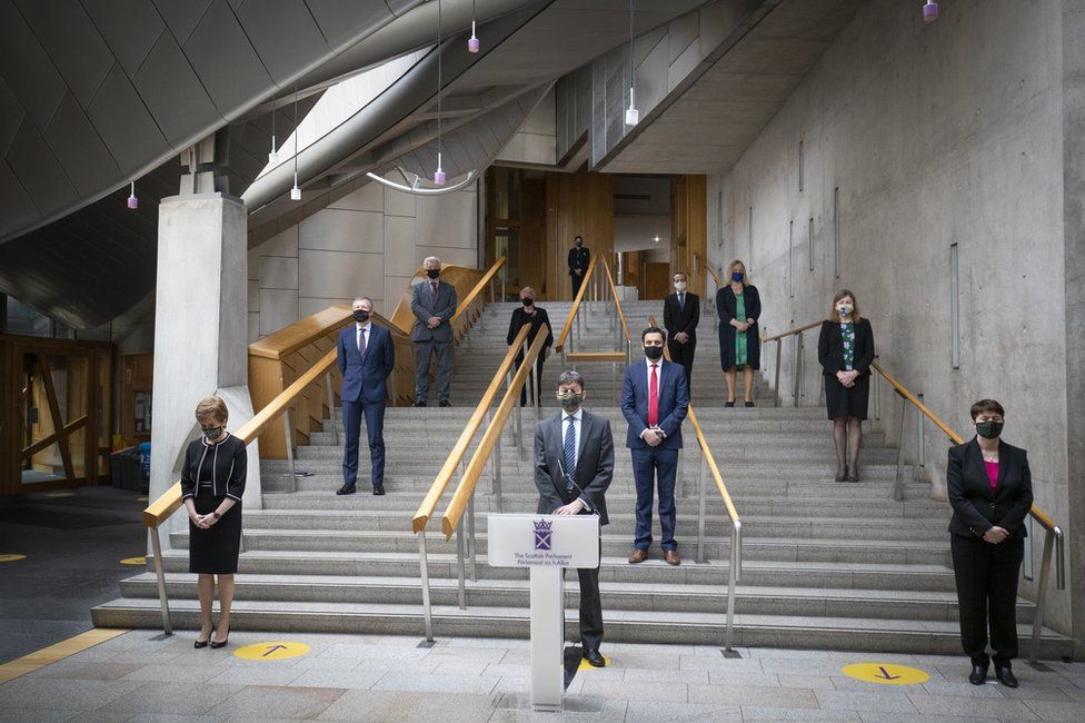 Members of the Scottish Parliament observe a minute's silence