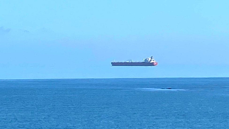 Hovering ship pictured off the coast of Cornwall Hovering ship pictured off the coast of Cornwall