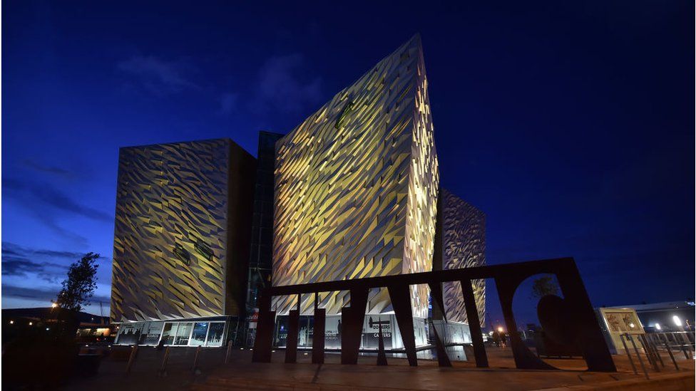 The Titanic building and visitor centre is lit up in yellow for the Day of Reflection on 23 March 2021 in Belfast, United Kingdom.