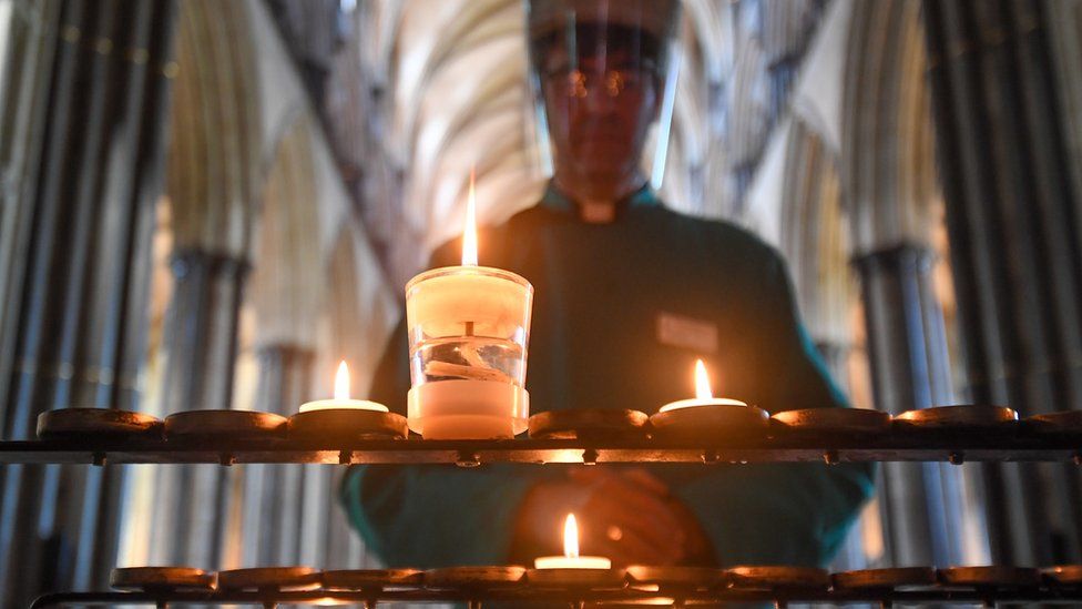 The Very Reverend Nicholas Papadopulos, Dean of Salisbury, lights a prayer candle inside the Cathedral on June 15, 2020 in Salisbury, United Kingdom