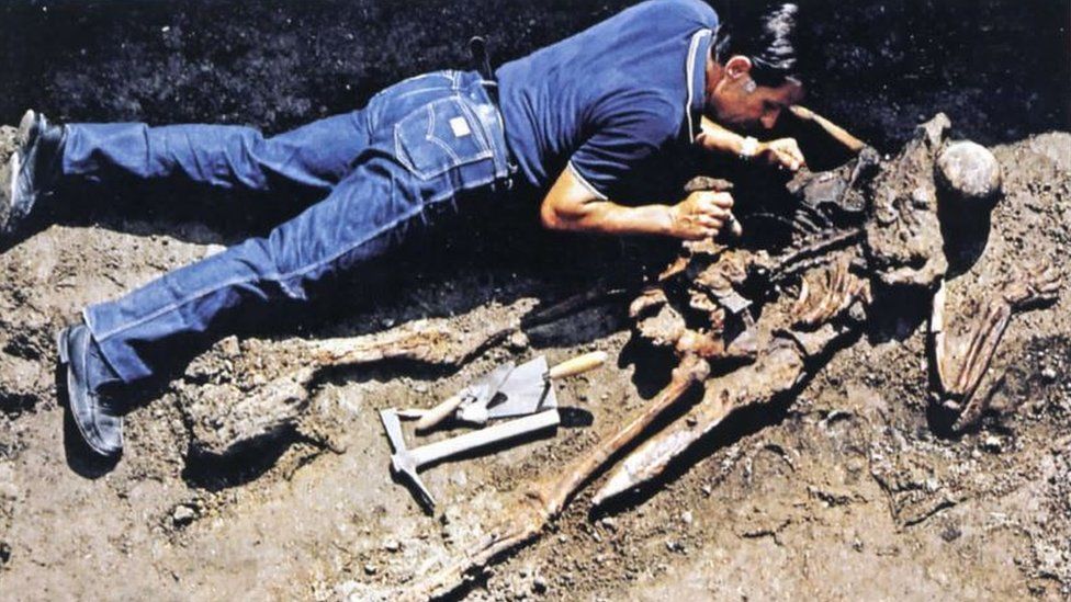 An archaeologist uncovers a skeleton at Herculaneum