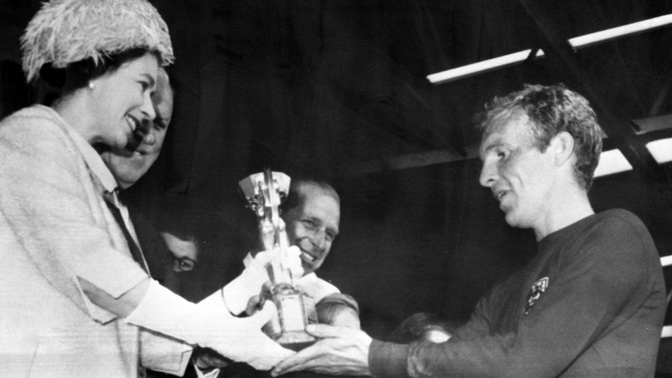 The Queen presents Bobby Moore with the Jules Rimet Trophy for winning the World Cup in 1966
