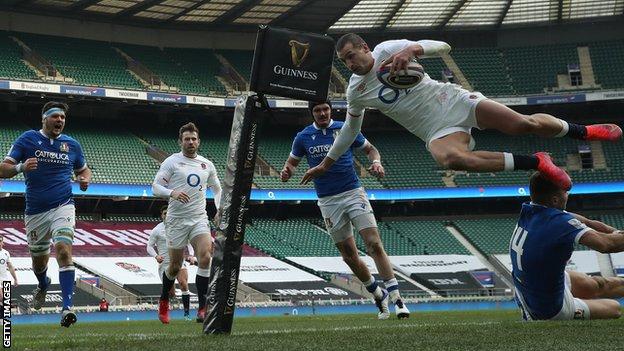 Jonny May jumps in the air to score a try