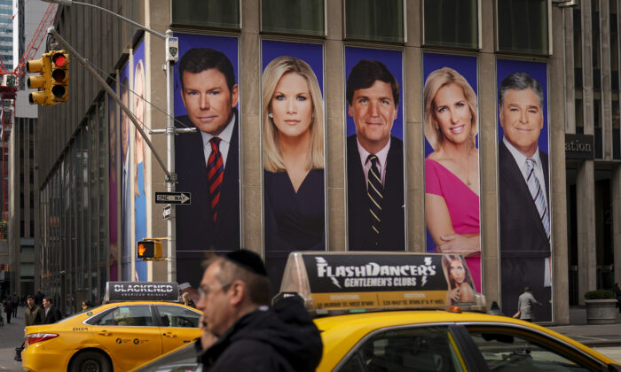 An advertisement features Fox News personalities, including Tucker Carlson and Sean Hannity, in New York City, on March 13, 2019. (Drew Angerer/Getty Images)