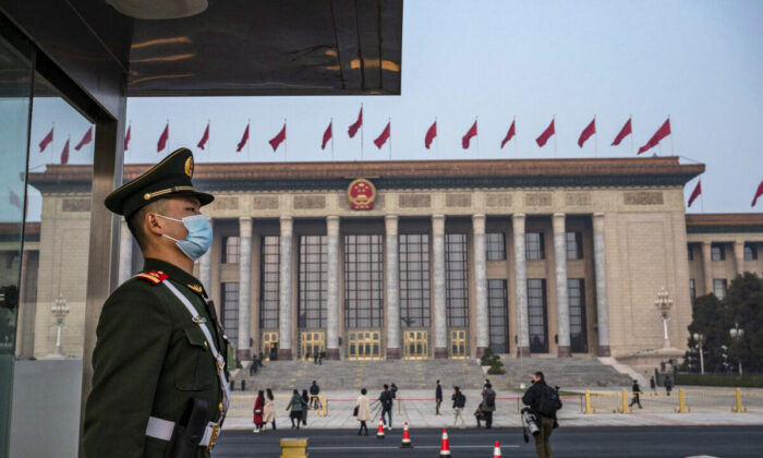 A police officer stands guard outside the Great Hall of the People in Beijing, China, on March 10, 2022. (Kevin Frayer/Getty Images)